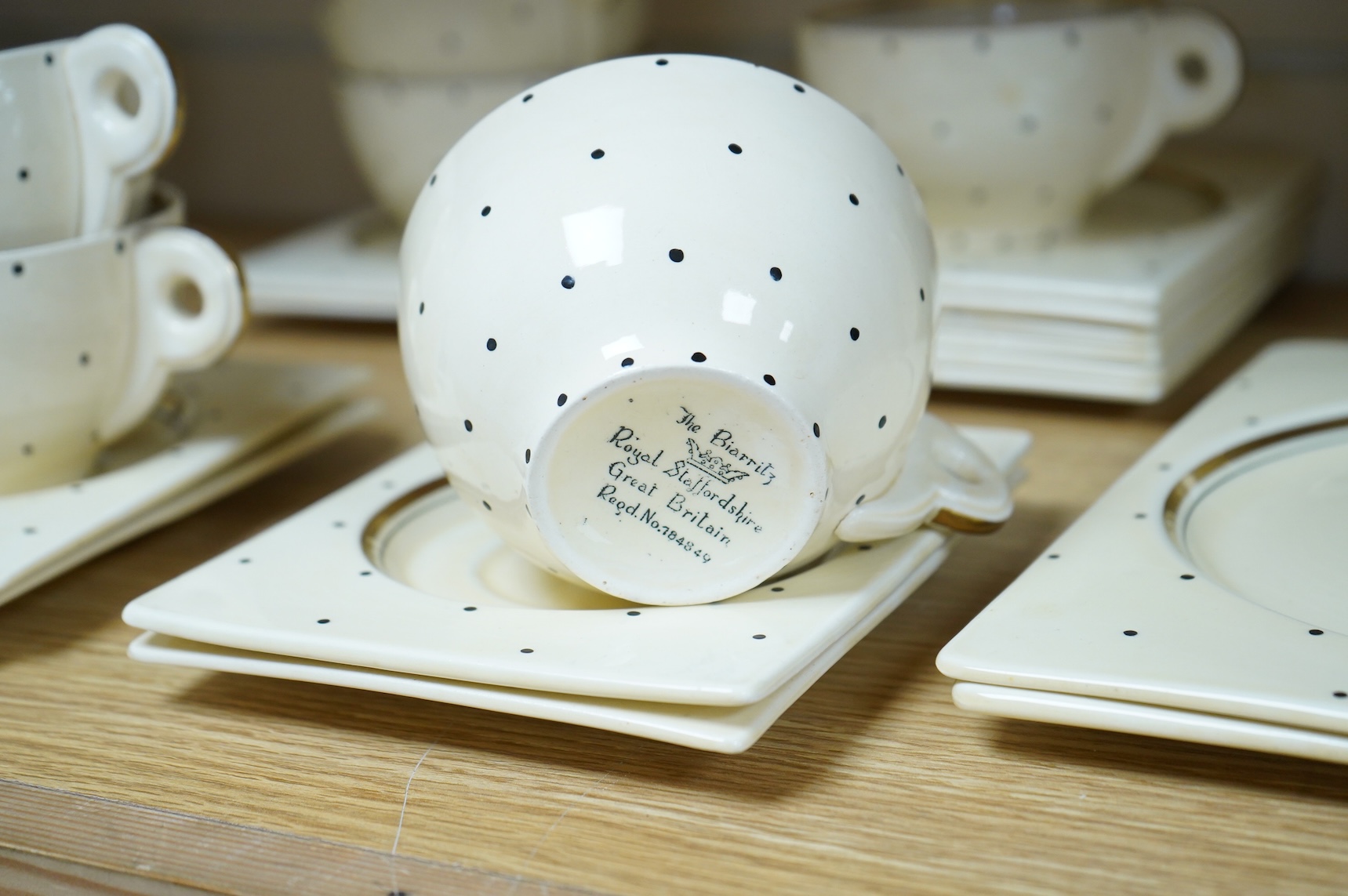 A Clarice Cliff Biarritz-shape 21-piece part teaset including trencher plates and saucers, impressed date-code 1935, jug 13cm